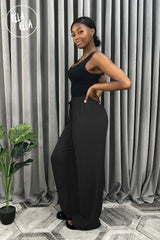 Full-length black plissé wide leg trousers side view