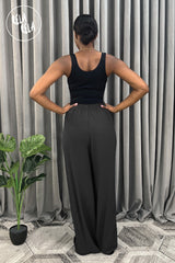 Back view of black plissé wide leg trousers