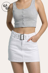 Front view of a model wearing the Rela Rela belted stretchy micro denim skirt in White. Highlights the ultra-short mini length, the matching denim belt, and the sculpting high-rise fit.