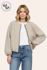 Front view of oversized beige zip-up bomber jacket for women
