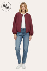 Model wearing oversized burgundy zip-up bomber jacket, pair with jeans