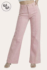 Model wearing RELA RELA Stretchy Blush Pink Pintuck Flare Jeans with front seam detailing, Y2K high-waisted fit.