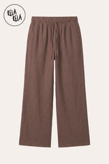 Professional flat lay of the Brown wide-leg linen trousers, emphasizing the deep earthy pigment and the high-quality drawstring craftsmanship.