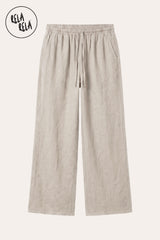 Professional flat lay of the Cream drawstring linen trousers, highlighting the lightweight breathable texture and the functional deep side pockets.