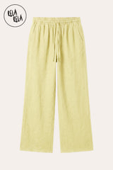 Professional flat lay of the Yellow linen wide-leg trousers, emphasizing the bright solar palette and the high-quality drawstring and pocket details.