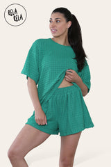 Woman wearing emerald green shorts co ord set with breathable crochet fabric