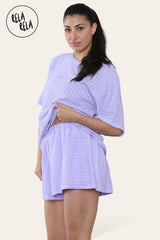 Woman wearing lilac shorts co ord set with breathable crochet fabric