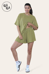 Woman wearing olive green shorts co ord set with breathable crochet fabric
