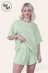 Model wearing green shorts co ord set – crochet texture two piece outfit