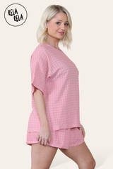 Side view of pink two piece outfit – oversized top and co-ordinating shorts