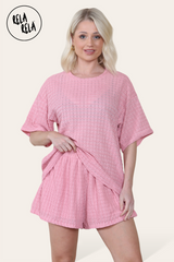 Model wearing pink shorts co ord set – crochet texture two piece outfit