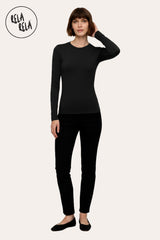 Model wearing black long sleeve basic t-shirt styled with jeans