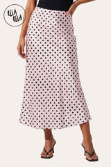 Front view of a model wearing Rela Rela Pink satin polka dot flowy maxi skirt, elegant outfit.