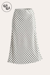 Professional flat lay of the Ivory White satin polka dot skirt, highlighting the sharp contrast of the black dots and the premium silk-like texture.