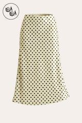 Professional flat lay of the Yellow satin polka dot maxi skirt, highlighting the bold colour contrast and the premium, silky fabric texture.