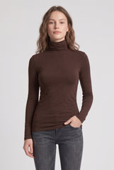 Front model view of the RELA RELA chocolate brown slim fit roll neck long sleeve layering top.