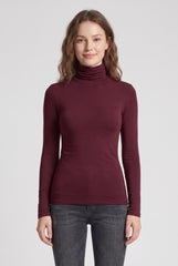Front model view of the RELA RELA burgundy slim fit roll neck long sleeve layering top.