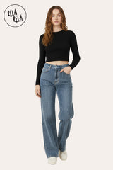 Lifestyle shot of woman wearing denim blue rhinestone dad fit jeans