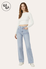 Lifestyle shot of woman wearing light blue rhinestone dad fit jeans