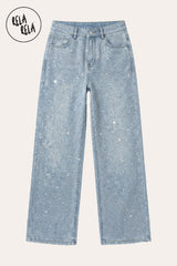 Flat Lay of multi colour mermaid rhinestones on stretchy light blue denim jeans