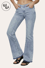 Front view of Viral stretchy low-waisted bootcut flared jeans in light blue on a petite model, featuring retro flap pocket details and a Y2K aesthetic.