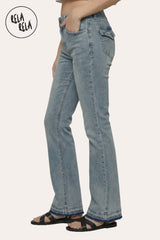 Side view of the viral stretchy bootcut flared jeans in Vintage Blue on a petite model, showcasing the authentic washed indigo and Y2K low-rise fit.