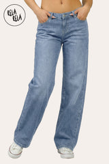 Front view of the viral stretchy wide leg jeans in Mid Blue on a petite model, showcasing the vintage wash and Y2K low-waisted fit.