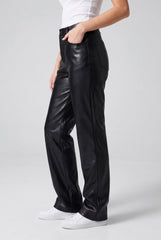 Side model view of RELA RELA Black high waist faux leather trousers, showing the straight wide-leg silhouette and pocket detail.