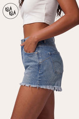 Additional angle of RELA RELA's Mid Blue frayed hem denim shorts showing the sculpted stretch fit.