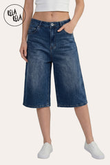 Front view of a model in Rela Rela’s Baggy Longline Denim Blue Jorts, highlighting the oversized Y2K silhouette and loose skater fit.