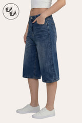 Side profile of the Blue denim jorts, showcasing the longline over-the-knee length and the voluminous wide-leg drape.