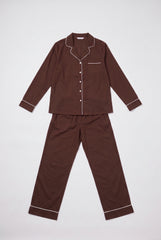 Flat product view of a two-piece chocolate pyjama set showing the long sleeve button-through shirt, white piping, chest pocket and matching long trousers.