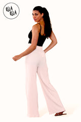 Back view of full-length beige plissé wide leg trousers – flattering pleated wide leg trousers elongating the legs.
