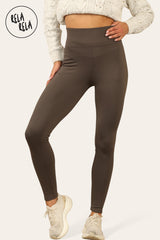 Model wearing chocolate fleece lined leggings styled with trainers