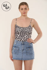Model wearing blue stretchy cargo denim skorts with a white tank top – front view