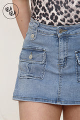 Close-up of utility cargo pocket on blue denim skorts for women
