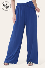 Close-up of navy blue plissé fabric – textured pleated wide leg trousers material detail.