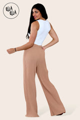 Back view of tan plissé wide leg trousers – adjustable drawstring waist on trousers with pleats.
