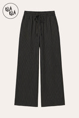 Flat lay of RELA RELA Black pinstripe trousers, showing the soft tonal pinstripe weave on jet ground, elastic waistband and relaxed wide-leg silhouette on a clean white background.