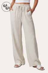 Front view of a model wearing RELA RELA White pinstripe relaxed-fit trousers with an elastic waistband, side pockets and wide-leg drape.