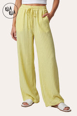 Front view of a model wearing RELA RELA Yellow pinstripe relaxed-fit trousers with an elastic waistband, side pockets and wide-leg drape.