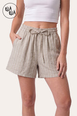 Front view of a model wearing Rela Rela's Beige vertical striped flowy loungewear shorts. Highlights the stretchy elastic waistband, faux linen fabric, and the relaxed flowy silhouette.
