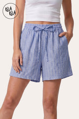 Front view of a model wearing Rela Rela's Blue vertical striped flowy loungewear shorts. Highlights the stretchy elastic waistband, faux linen fabric, and the relaxed flowy silhouette.