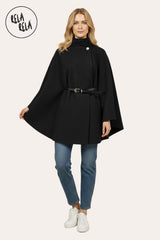 Model wearing black belted high neck poncho cape jacket paired with autumn outfit.
