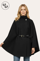 Front view of black belted poncho cape jacket with high neck and button closure.