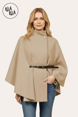 Front view of camel belted poncho cape jacket with high neck and button closure.