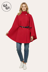 Model wearing red belted high neck poncho cape jacket paired with autumn outfit.