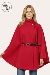 Front view of red belted poncho cape jacket with high neck and button closure.