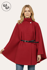 Front view of burgundy belted poncho cape jacket with high neck and button closure.