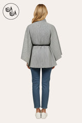 Back view of charcoal high neck poncho cape jacket showing relaxed fit and belted waist.